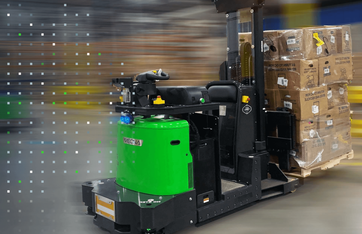 Photo of a self-driving forklift robot moving a pallet full of boxes