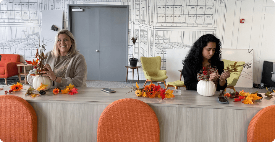 Photo of two women making pumpkin arrangements