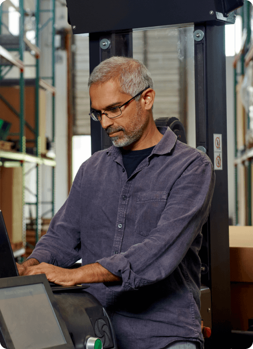 Photo of a man working on a laptop computer