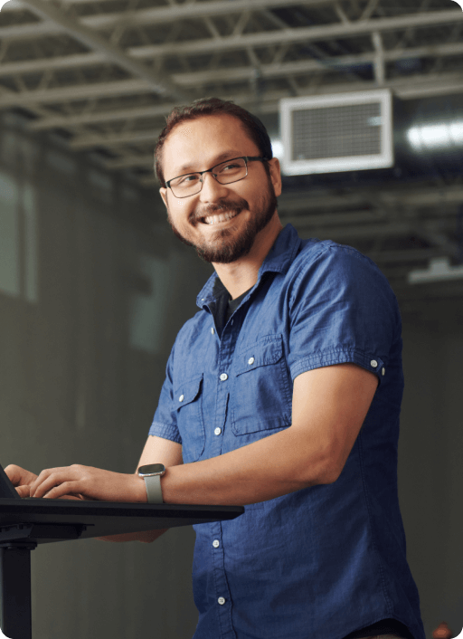 Photo of a man standing at a desk