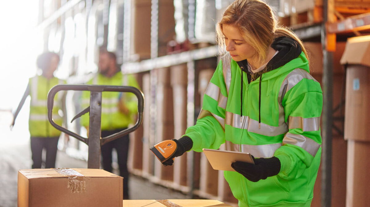 A woman scanning a barcode on a box